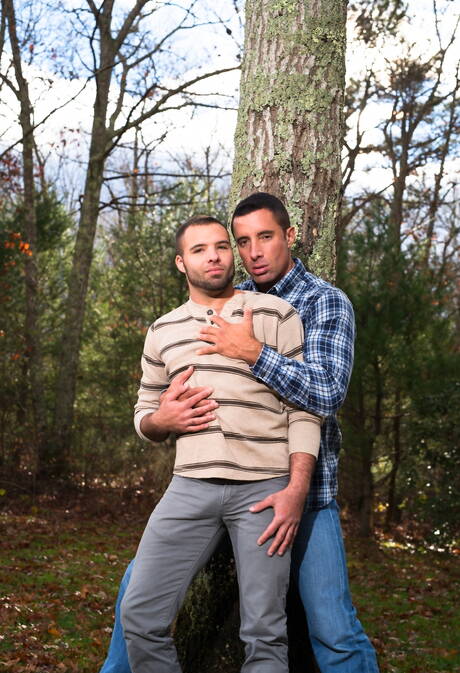 Mature Nick Capra posing with hot young gays outdoors